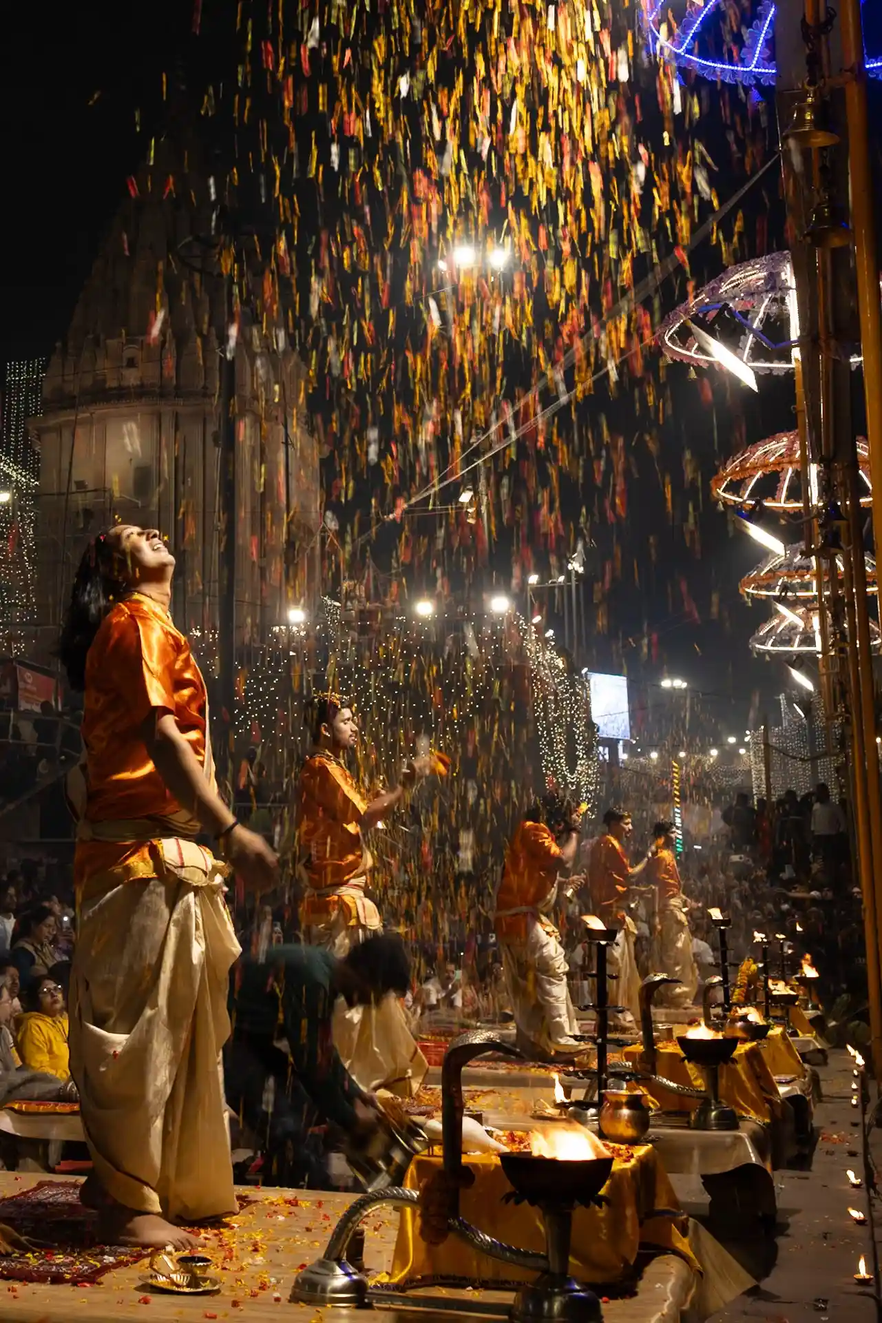 A priest performing the Dev Deepawali Ganga Aarti with a large ceremonial flame